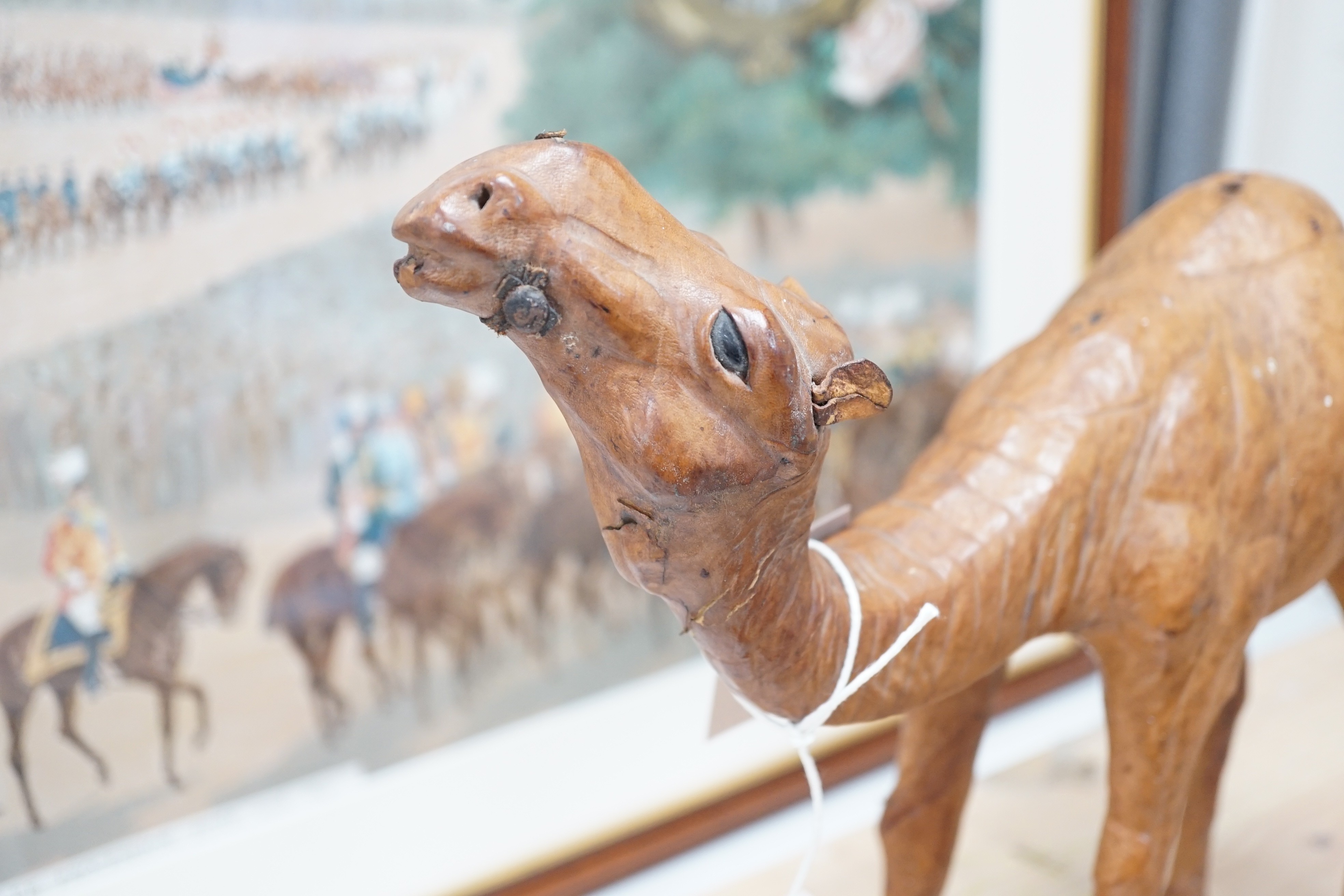 A leather covered model of a camel 32cm long